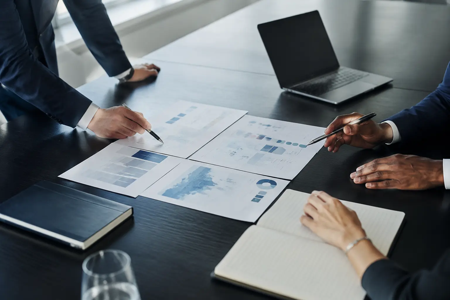 Business leaders reviewing strategic analysis around a boardroom table